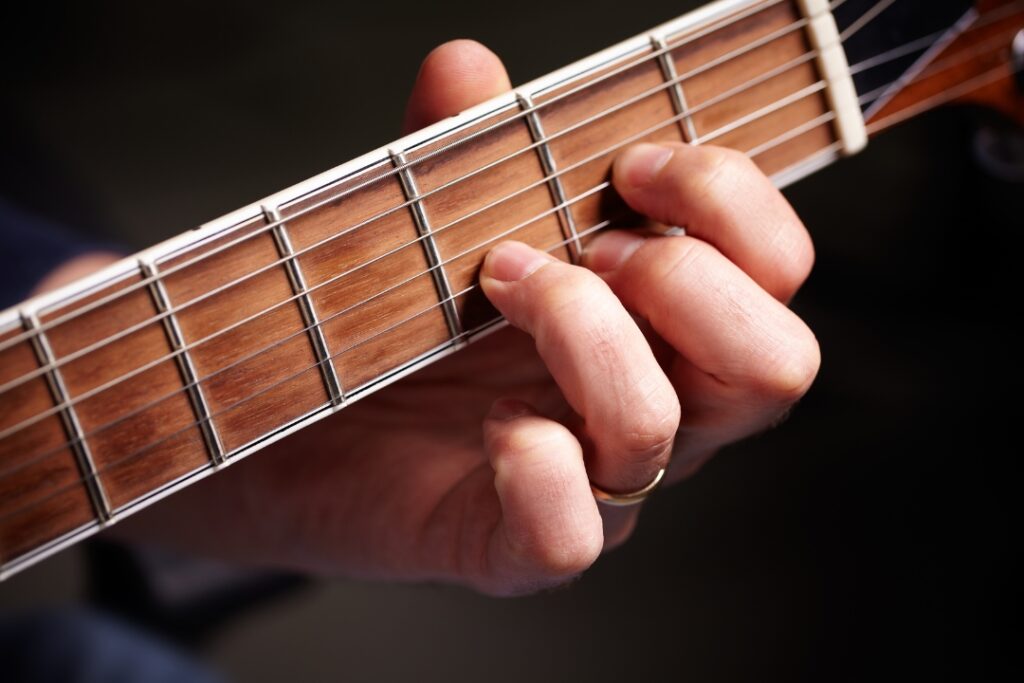 guitarist playing one of the basic guitar chords